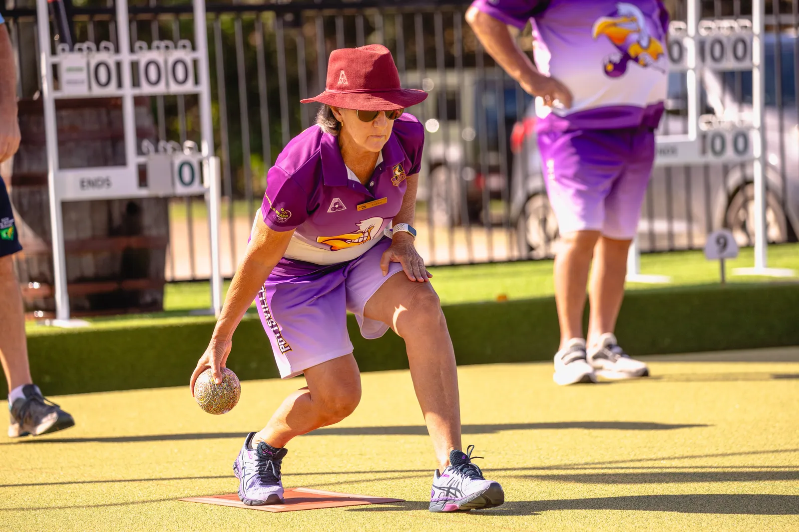 A bowler delivering on the green in golden afternoon light