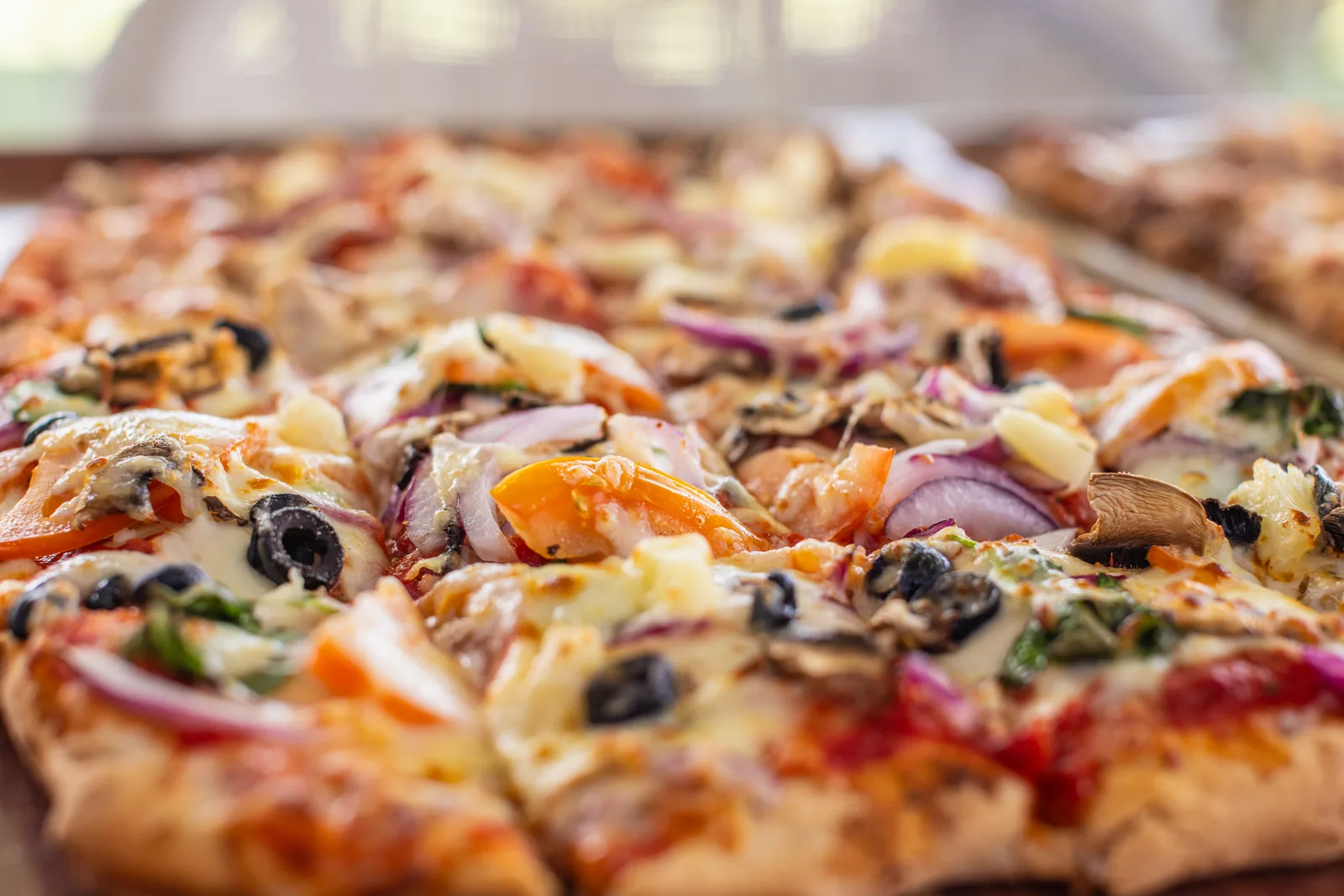 A freshly baked supreme pizza, sliced and ready to serve